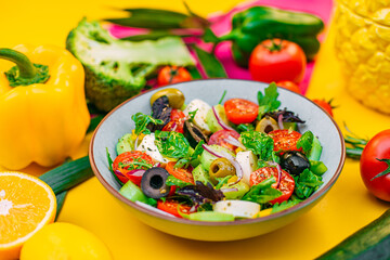 healthy food. Greek Salad with cheese, cucumbers, tomatoes and olives on a decorated table