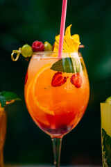 tropical cocktail with berries and fruits on a decorated table