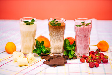 milkshake with berries and fruits on a decorated table
