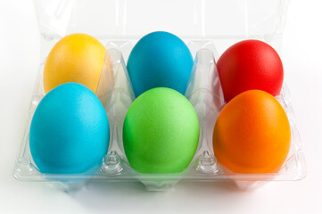 Colored Easter Eggs in egg box on the white background