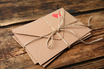 Stack of envelopes on wooden table. Love letters