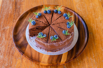 chocolate with blueberry cake on a wooden plate