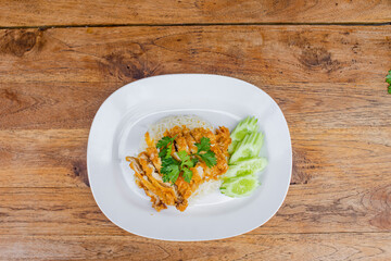 Fried chicken pieces with rice on a white plate 