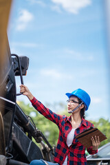 A female engineer is inspecting work at the construction site.