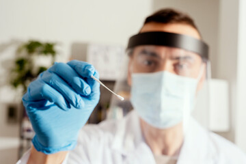 male nurse about to take a nasopharyngeal culture