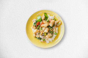 Stir fried dory fish on a yellow plate