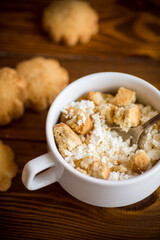 Homemade cottage cheese with pieces of shortbread cookies for breakfast