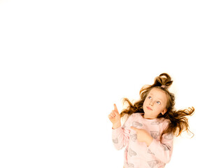 little girl points a finger on a white background