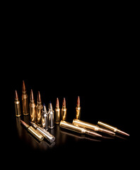 Bullet isolated on black background with reflexion. Rifle bullets close-up on black back....