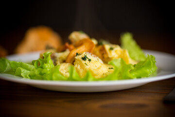 fried omelet with forest mushrooms chanterelles, on table