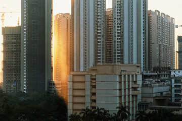 A skyline of highrises in the suburb of Kandivali in the city of Mumbai in the golden hour of the evening.