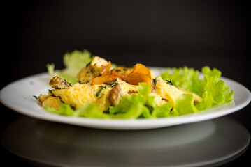 fried omelet with forest mushrooms chanterelles, on black background