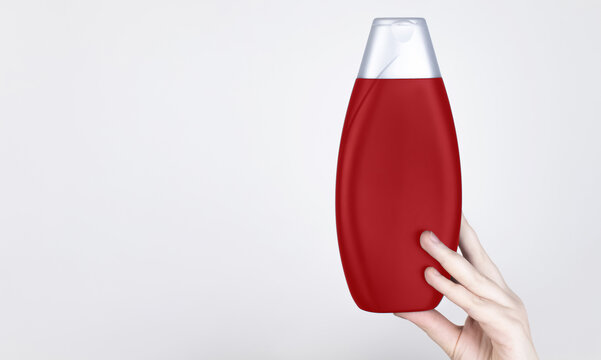 Chemical components of the shampoo. A woman's hand holds a black jar of shampoo. Place for text. Conception of the harm of chemical cosmetics or the benefits of organic chemicals for home