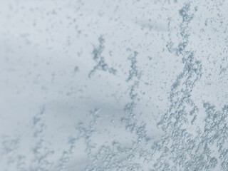Fototapeta na wymiar Close Up Winter Ice and Snow Sticking to Glass Window