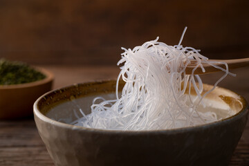 Close up Fresh Glass Noodle (Transparent bean vermicelli) on wooden fork