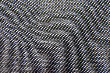 Black denim close up. Fabric macro texture and background