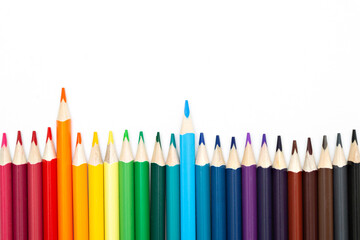 Top view of colorful pencils on white background