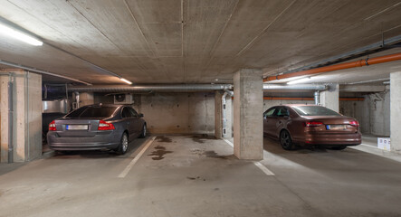 Fototapeta na wymiar Cars on underground parking in modern residential complex.