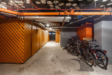 Bicycles on underground parking in modern residential complex.