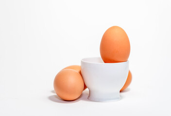 Fresh ogranic chicken eggs in white cup.