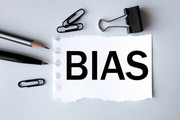 BIAS. text, word, on white paper on gray background.
