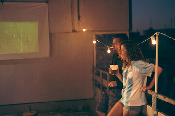 Football fans drinking beer while watching game