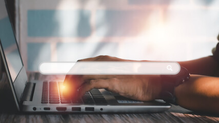 Search engine browser concept. Hand typing on laptop or computer searching for job, e-learning, shopping, and working online at home.