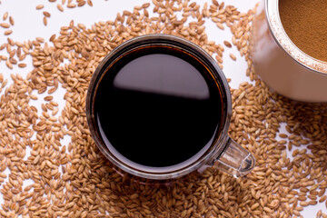 A cereal drink to replace coffee. Cup with coffee on a beige background close up