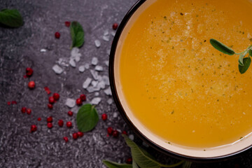selective focus. Homemade Beef Bone Broth in a deep soup bowl. on a dark background. with the addition of spices-salt and pepper. Bones contain collagen, which provides the body with amino acids