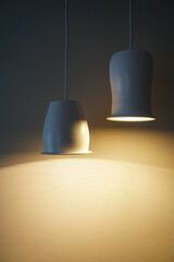 Two hanging lighted lamps with ceramic plafonds