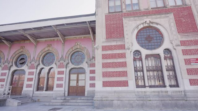 Old Train Station in Istanbul. Action. Small station building with red facade and round windows in style of 19th century. Turkish Railway Station in Istanbul