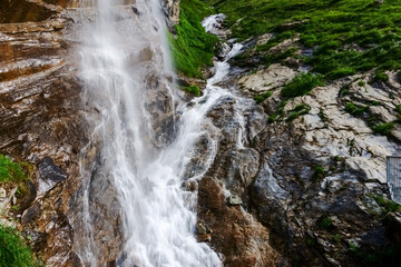 step waterfall over a cliff in the mountains detail