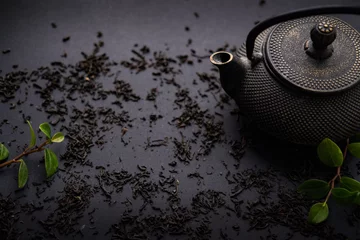 Foto op Aluminium tea ceremony . lemon tea honey teapot on black background. copy space. © kristina