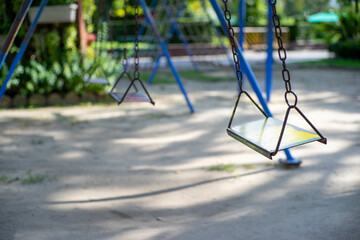 Empty swing on children playground in the park