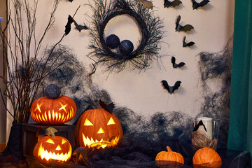 Halloween composition in the room. Pumpkins, spider webs and bats. The atmosphere of horror for the...