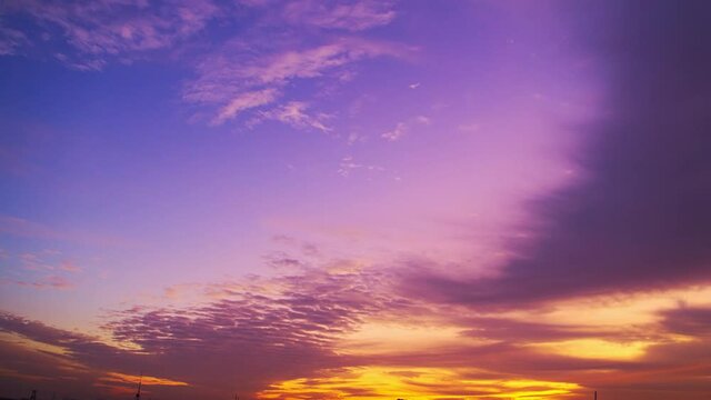 Time-lapse, sky at dusk, purple and golden clouds