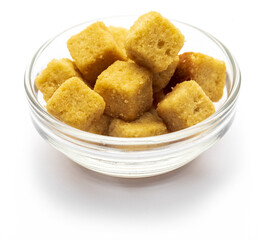 Bowl of crispy croutons. Cubes of bread toasted and fried in oil. Isolated white background