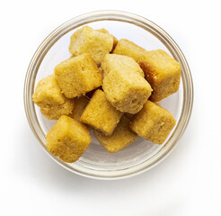 Bowl of crispy croutons. Cubes of bread toasted and fried in oil. Isolated white background