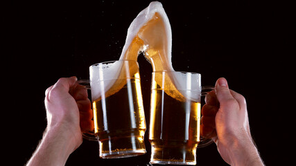 Pair of beer glasses with hand making a toast
