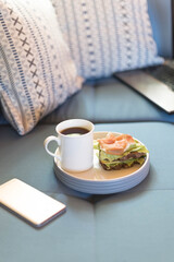 working on laptop computer sitting at home and managing business home office during Coronavirus or Covid-19 quarantine and drink coffee eating sandwich
Student freelancer lifestyle.