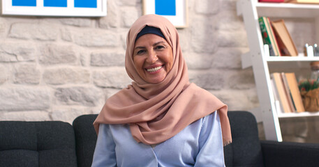 Beautiful face portrait of happy mature middle-aged woman in turban. Elderly woman in turban, healthy cheerful smiling, looking at camera posing at home, looking for portrait.
