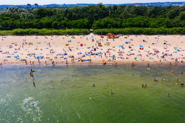Crowded beach during summertime aerial view - obrazy, fototapety, plakaty