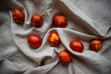 Easter Eggs Decorated with Natural Fresh Leaves and Boiled in Onions Peels on gray linen tablecloth. Happy Easter concept. Eco Easter eggs.  Zero waste Easter.