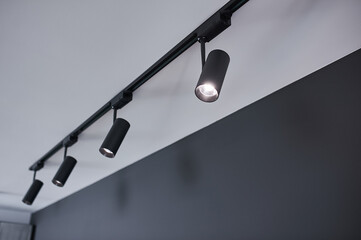 A group of hanging black metal lights.