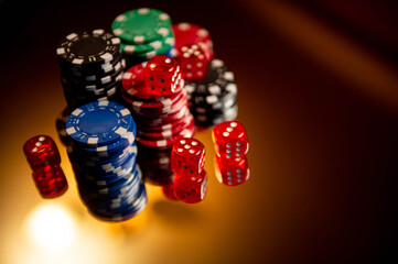 Casino. Poker. Game pieces and dice are on the table. Game chips for betting in gambling. Dice. Poker chips. 