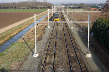 Train at high speed on the railway from above in the Netherlands