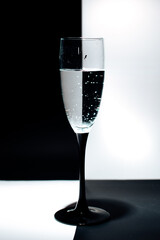 a glass of water on a black and white background