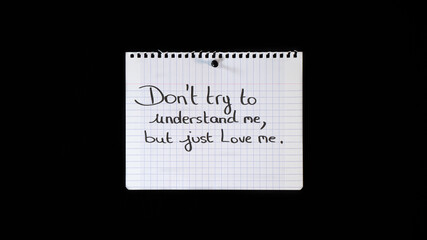 Hand written message on a ripped notebook sheet: Don't try to understand me, but just love me