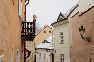 Fascinating narrow picturesque street with baroque and renaissance historical buildings, snow in winter day, Novy svet, New World in vicinity of Hradcany, Prague, Czech Republic