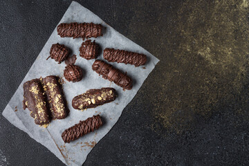 Natural chocolate bars with peanuts and coconut chips without white refined sugar. Healthy eating.